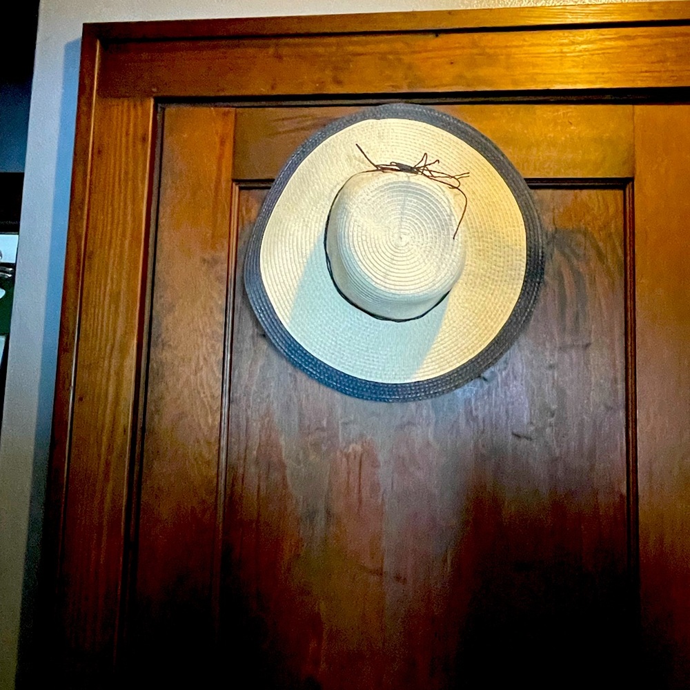 Straw and navy blue sun hat.